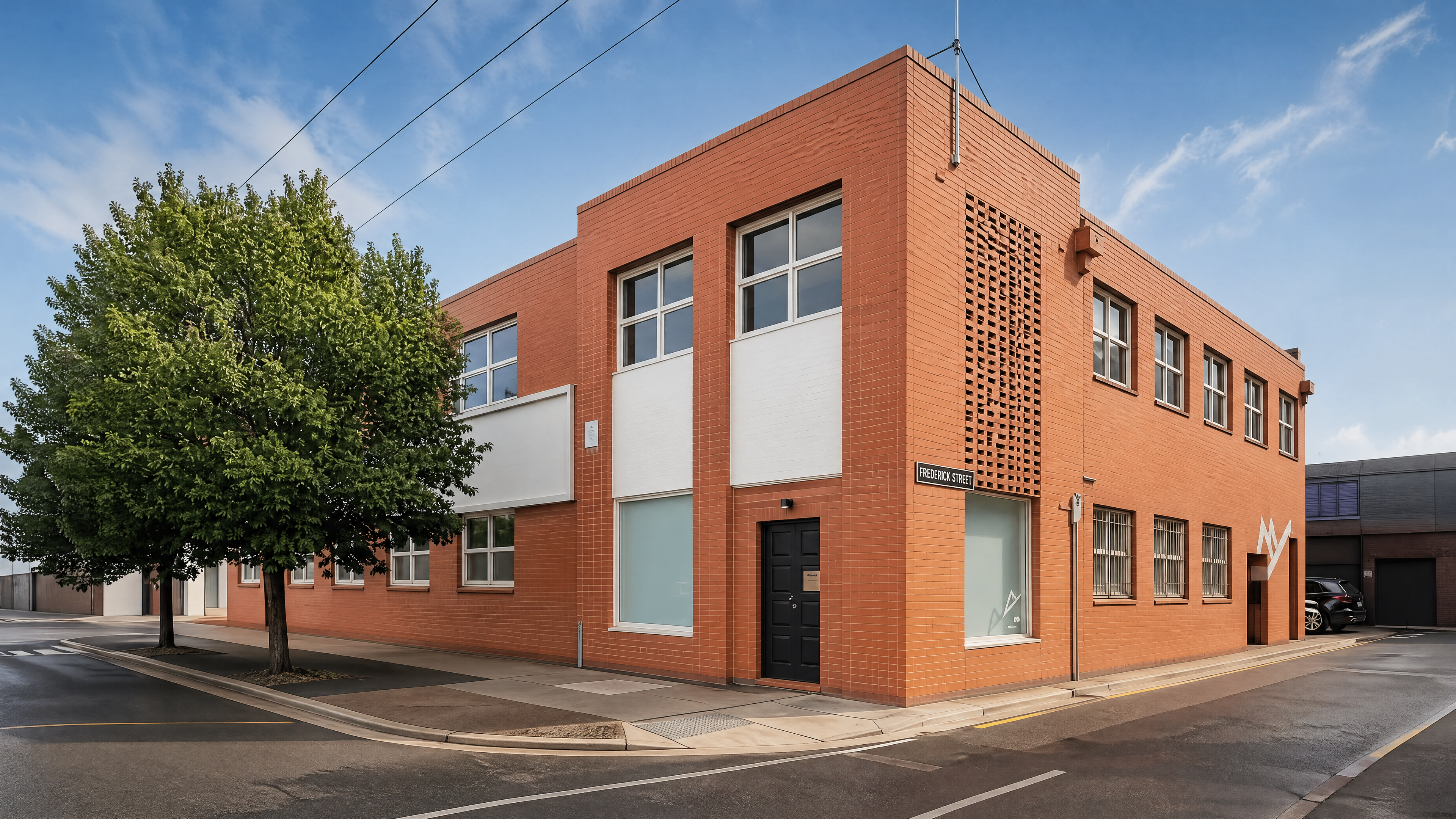 The Sturt Street building exterior — two-storey red brick warehouse.