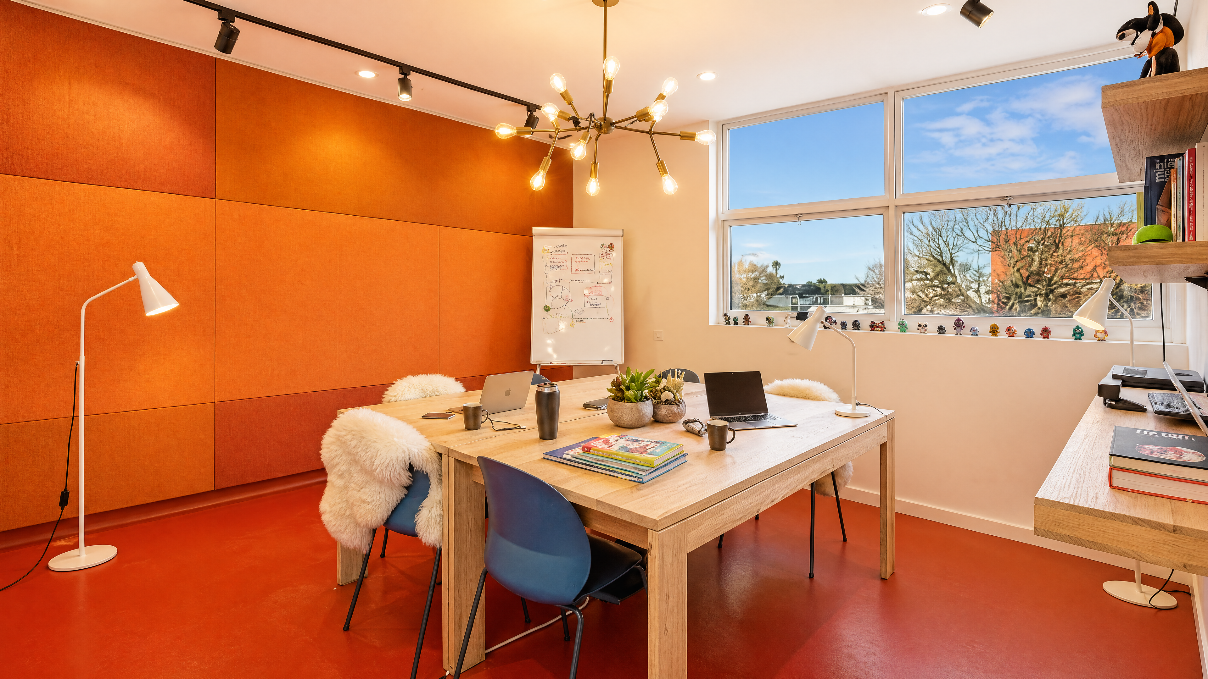 Larger meeting room — terracotta acoustic panels, sash window.
